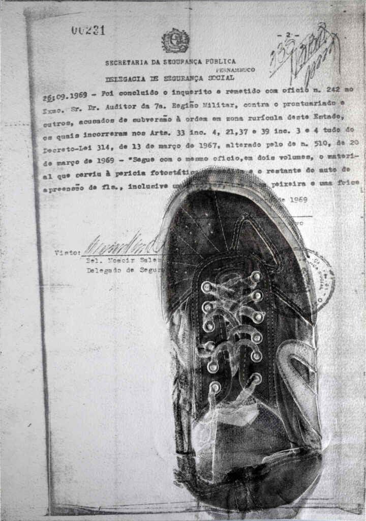 A black-and-white print of a shoe on one side of a labelled sheet of paper.